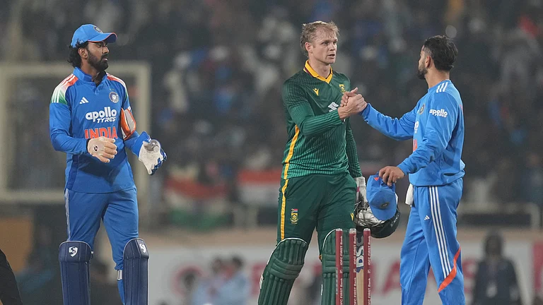 India's Virat Kohli, right, shakes hands with South Africa's Corbin Bosch after India won the first One Day International match in Ranchi, India, Sunday, Nov. 30, 2025. - (AP Photo/Rafiq Maqbool)