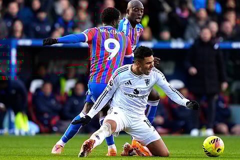 Manchester United's Casemiro, front, is challenged by Crystal Palace's Eddie Nketiah during the English Premier League soccer match between Crystal Palace and Manchester United in London.