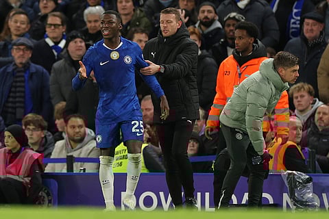 Chelsea's Moises Caicedo reacts from the touchline after getting a red card during the English Premier League soccer match between Chelsea and Arsenal in London, England.