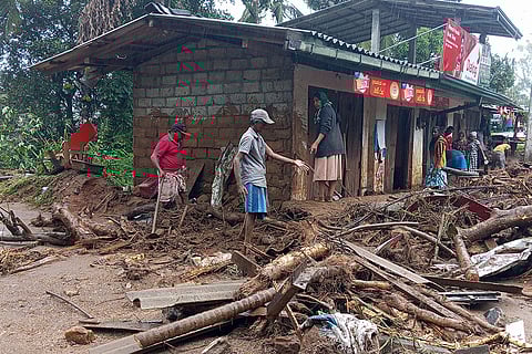 Landslide survivors clean the debris in Hanguranketha, Sri Lanka.