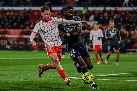 Real Madrid's Antonio Rudiger, right, fights for the ball with Girona's Vladyslav Vanat during a Spanish La Liga soccer match between Girona and Real Madrid, in Girona, Spain.
