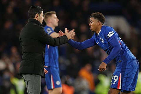 Arsenal's manager Mikel Arteta, left, cheers Chelsea's Wesley Fofana after the English Premier League soccer match between Chelsea and Arsenal in London, England.