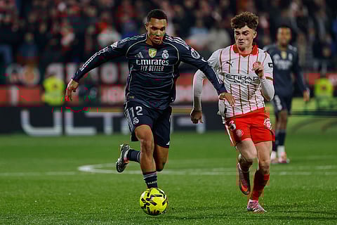 Real Madrid's Trent Alexander-Arnold, left, fights for the ball with Girona's Joel Roca during a Spanish La Liga soccer match between Girona and Real Madrid, in Girona, Spain.