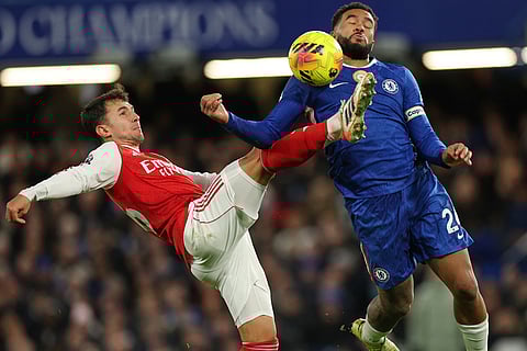 Arsenal's Martin Zubimendi, left, challenges for the ball with Chelsea's Reece James during the English Premier League soccer match between Chelsea and Arsenal in London, England.