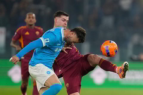 Napoli's Amir Rrahmani challenge for the ball with Roma's Evan Ferguson during the Serie A soccer match between Roma and Napoli in Rome.