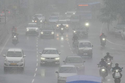 Vehicles move amid rain due to Cyclone Ditwah, in Chennai.