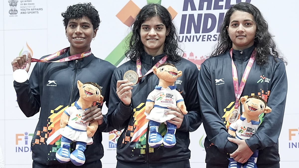 Special Arrangement : Pratyasa Ray (center) poses with her gold medal at KIUG Rajasthan 2025
