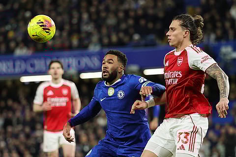 Arsenal's Riccardo Calafiori, right, challenges for the ball with Chelsea's Reece James during the English Premier League soccer match between Chelsea and Arsenal in London, England.