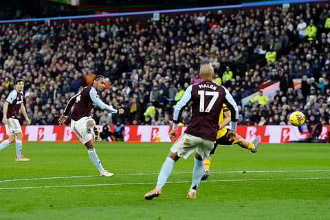 Aston Villa's Boubacar Kamara, second left, scores his side's first goal, during the English Premier League soccer match between Aston Villa and Wolverhampton Wanderers, at Villa Park, in Birmingham, England.