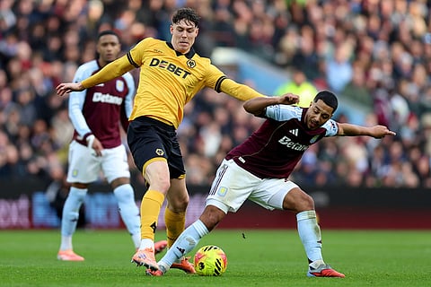 Wolverhampton Wanderers' Jorgen Strand Larsen, left and Aston Villa's Youri Tielemans vie for the ball, during the English Premier League soccer match between Aston Villa and Wolverhampton Wanderers, at Villa Park, in Birmingham, England.