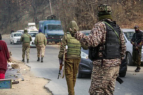 Security officials keep vigil during a raid, in Pulwama. The National Investigation Agency (NIA) carried out raids at eight locations in Pulwama, Shopian and Kulgam districts of Kashmir in connection with a "white-collar" terror module that was behind a car blast near Delhi's Red Fort. 