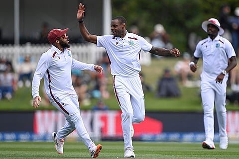 West Indies' Justin Greaves, center, celebrates with teammate John Campbell after taking the wicket of New Zealand's Tom Latham during their cricket test match in Christchurch, New Zealand.