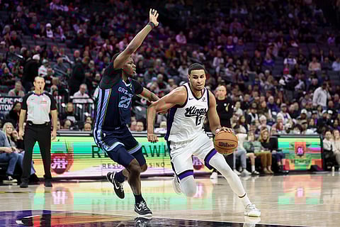 Sacramento Kings forward Keegan Murray (13) drives to the basket with Memphis Grizzlies guard Cedric Coward (23) defending during the second half of an NBA basketball game in Sacramento, California. 