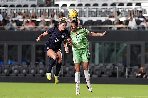 United States forward Emma Sears, left, vies with Italy defender Martina Lenzini, right, for a header during the second half of an international friendly soccer match in Fort Lauderdale, Fla.