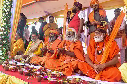 Sadhus perform rituals at the banks of the Ganga river as part of the 'Magh Mela 2026', in Prayagraj.