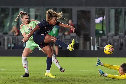 United States forward Catarina Macario kicks the ball into the net past Italy goalkeeper Francesca Durante, right, and Italy defender Cecilia Salvai, left, for a would-be third goal which was invalidated by a foul call, during the second half of an international friendly soccer match in Fort Lauderdale, Fla.