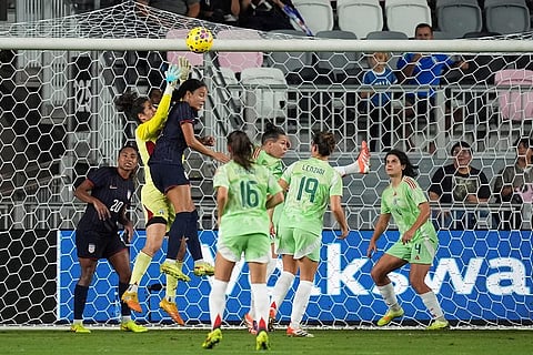 Italy goalkeeper Francesca Durante (22) jumps to deflect a shot against United States defender Jordyn Bugg (2) during the first half of an international friendly soccer match in Fort Lauderdale, Fla.