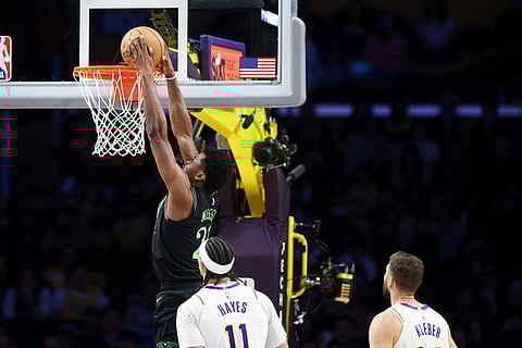 New Orleans Pelicans center Yves Missi, left, dunks as Los Angeles Lakers center Jaxson Hayes (11) and Los Angeles Lakers forward Maxi Kleber, right, watch during the second half of an NBA basketball game in Los Angeles. 