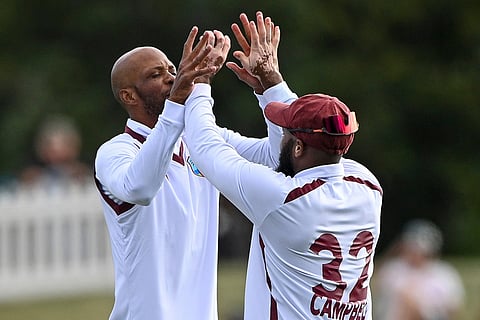 West Indies' Roston Chase, left, and teammate John Campbell celebrate after taking the wicket of New Zealand's Nathan Smith during their cricket test match in Christchurch, New Zealand.