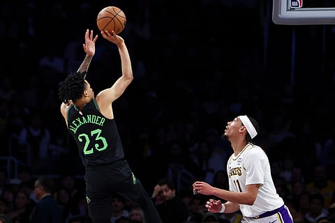 New Orleans Pelicans guard Trey Alexander (23) shoots as Los Angeles Lakers center Jaxson Hayes (11) watches during the second half of an NBA basketball game in Los Angeles. 