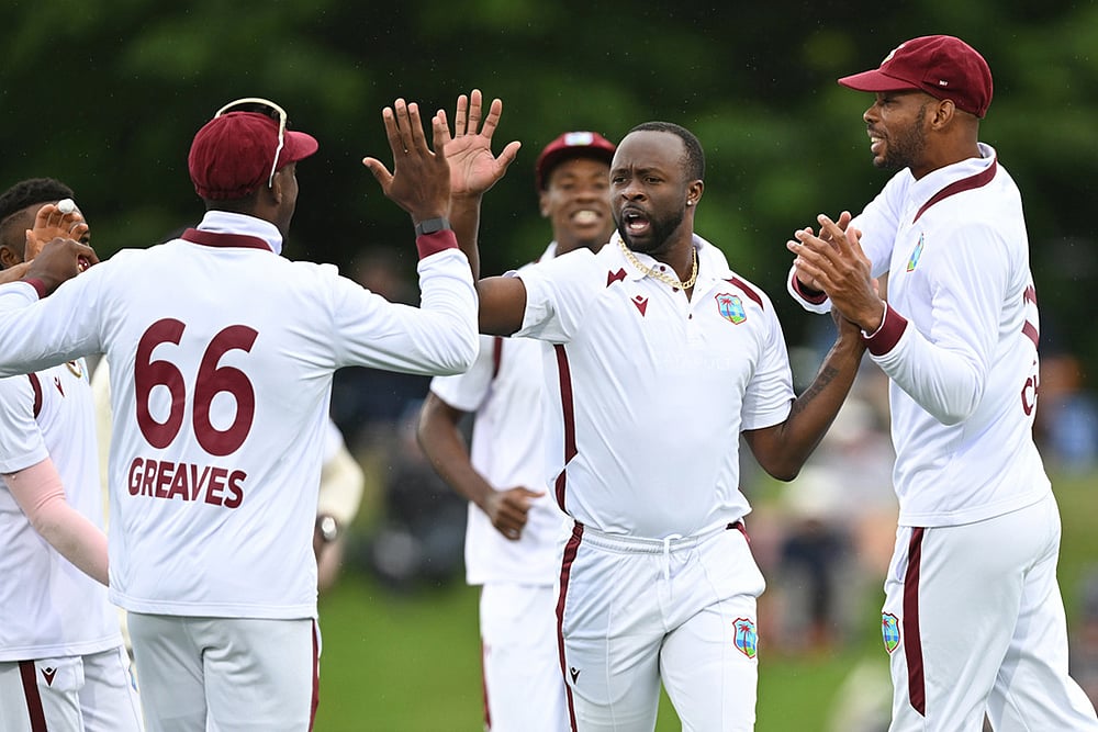 West Indies bowler Kemar Roach, second right, celebrates with teammates after taking the wicket of New Zealand's Devon Conway during their cricket test match in Christchurch, New Zealand. - | Photo: Andrew Cornaga/Photosport via AP