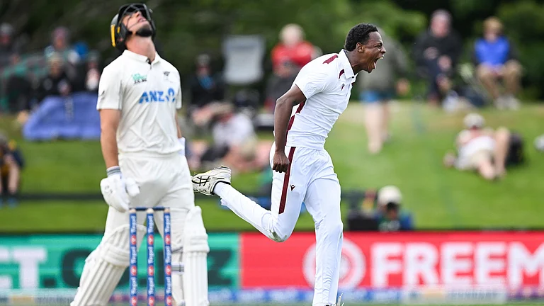 West Indies bowler Johann Layne celebrates the wicket of New Zealand's Will Youn during their cricket test match in Christchurch on December 2, 2025. - | Photo: AP/Andrew Cornaga