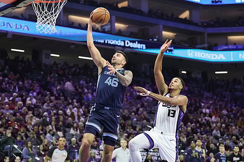 Memphis Grizzlies guard John Konchar (46) makes a layup on a fast break with Sacramento Kings forward Keegan Murray (13) defending during the first half of an NBA basketball game in Sacramento, California. 