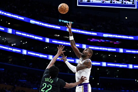 Los Angeles Lakers center Deandre Ayton, right, shoots against New Orleans Pelicans center Derik Queen (22) during the second half of an NBA basketball game in Los Angeles. 