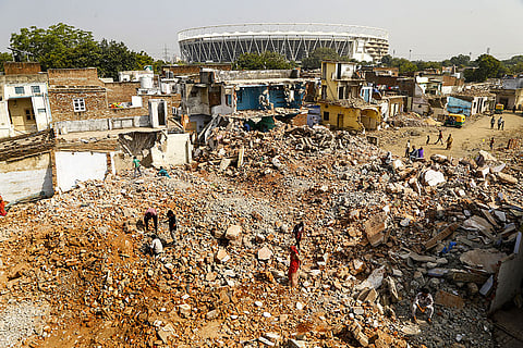Residents look for their belongings amidst the debris after an anti-encroachment drive by the Municipal Corporation ahead of the 2030 Commonwealth Games, near the Narendra Modi stadium, in Ahmedabad.