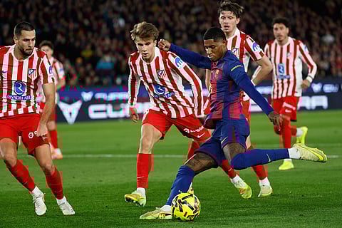 Barcelona's Marcus Rashford fights for the ball against Atletico Madrid's Pablo Barrios during a Spanish La Liga soccer match between Barcelona and Atletico de Madrid, in Barcelona, Spain.