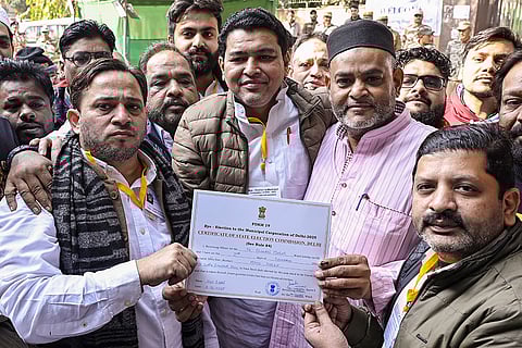 All India Forward Bloc candidate Mohd. Imran Choudhary and supporters celebrate after winning the Chandni Mahal seat in the MCD bye-election, in New Delhi.