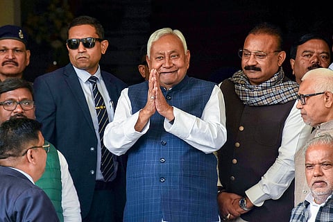 Bihar Chief Minister Nitish Kumar, center, greets as he arrives to attend the Winter session of the state Assembly, in Patna.