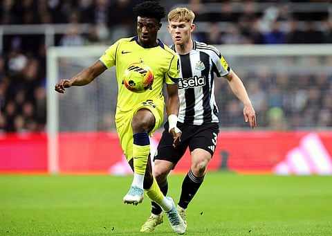 Tottenham Hotspur's Mohammed Kudus, left, and Newcastle United's Lewis Hall battle for the ball during their English Premier League soccer match in Newcastle, England.