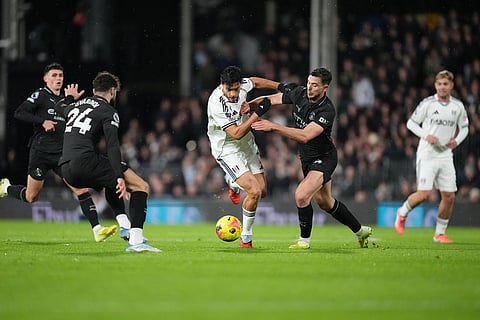 Manchester City's Nico Gonzalez, center right, fights for the ball with Fulham's Raul Jimenez, center left, during the English Premier League soccer match between Fulham and Manchester City in London.