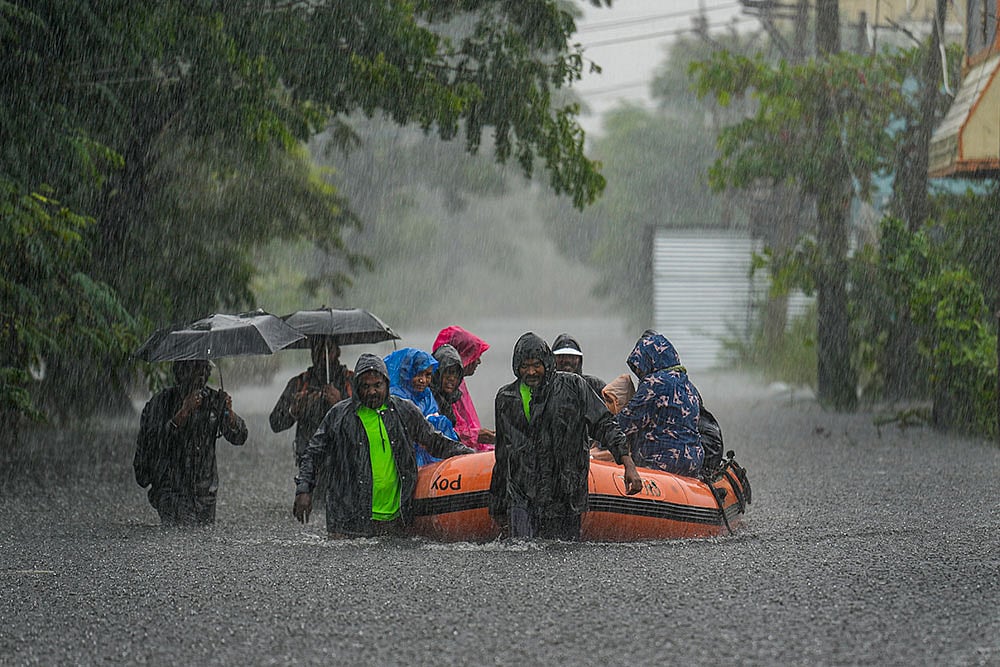 People being rescued from a flood-affected area amid rainfall, in view of Cyclone Ditwah, in Chennai. - Photo: PTI/R Senthilkumar