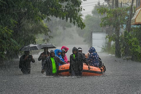 People being rescued from a flood-affected area amid rainfall, in view of Cyclone Ditwah, in Chennai.