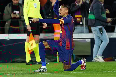 Barcelona's Raphinha celebrates his side's first goal during a Spanish La Liga soccer match between Barcelona and Atletico de Madrid, in Barcelona, Spain.