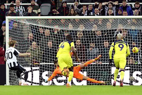 Newcastle United's Anthony Gordon, left, scores their side's second goal of the gameduring the Premier League soccer match between Newcastle United and Tottenham Hotspur in Newcastle, England.