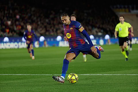 Barcelona's Raphinha kicks the ball during a Spanish La Liga soccer match between Barcelona and Atletico de Madrid, in Barcelona, Spain.