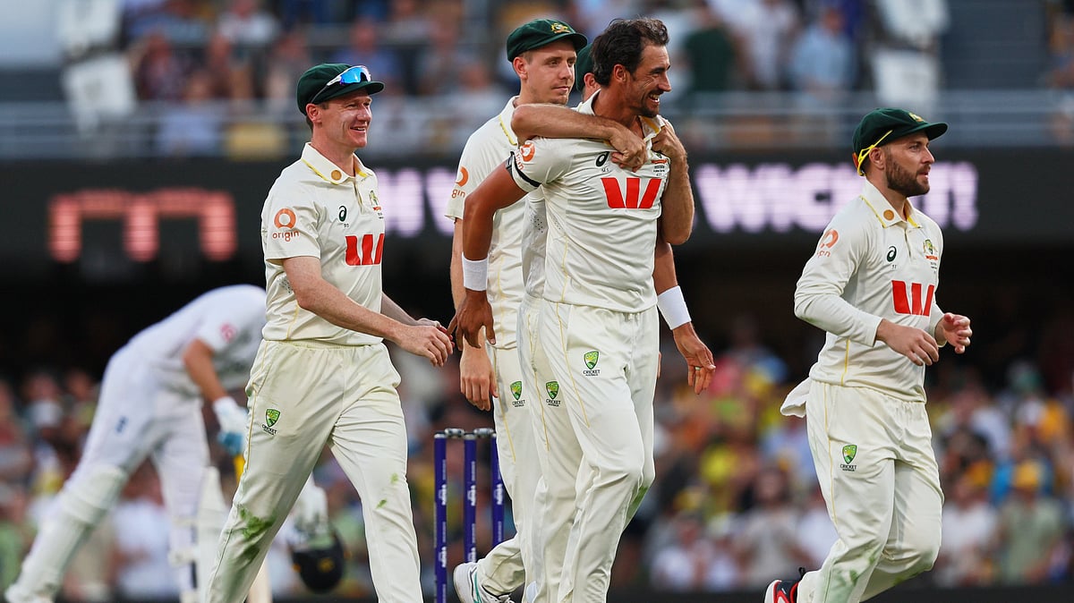 Australia's Mitchell Starc, centre, celebrates with teammate the wicket of during the second Ashes cricket test match between Australia and England in Brisbane, Thursday, Dec. 4, 2025. - AP Photo/Tertius Pickard