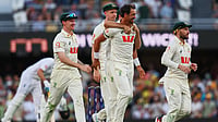 AP Photo/Tertius Pickard : Australia's Mitchell Starc, centre, celebrates with teammate the wicket of during the second Ashes cricket test match between Australia and England in Brisbane, Thursday, Dec. 4, 2025.