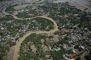 | Photo: AP/Reza Saifullah : This aerial photo taken from a national disaster mitigation agency's helicopter during an aerial aid distribution shows an area affected by floods in Pidie Jaya, Aceh province, Indonesia.