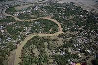 Indonesia Floods: One Million Evacuated And Over 700 Dead | Photo: AP/Reza Saifullah : This aerial photo taken from a national disaster mitigation agency's helicopter during an aerial aid distribution shows an area affected by floods in Pidie Jaya, Aceh province, Indonesia.