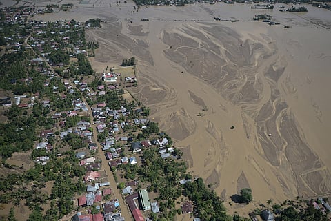 This aerial photo taken from a national disaster mitigation agency's helicopter during an aerial aid distribution shows an area affected by floods in Pidie Jaya, Aceh province, Indonesia.