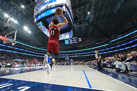 Miami Heat forward Jaime Jaquez Jr. tries to keep the ball in bounds against the Dallas Mavericks during the first half of an NBA basketball game in Dallas. 