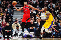 | Frank Gunn/The Canadian Press via AP : Toronto Raptors' Scottie Barnes (4) looks to pass the ball over Los Angeles Lakers' LeBron James, right, during second-half NBA basketball game action in Toronto.