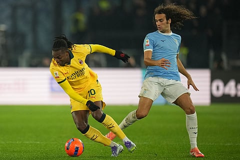 AC Milan's Rafael Leao, left, and Lazio's Matteo Guendouzi fight for the ball during the Italian Cup round of sixteen soccer match between Lazio and Milan, in Rome.