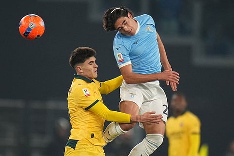 AC Milan's Davide Bartesaghi, left, and Lazio's Elseid Hysaj jump for the ball during the Italian Cup round of sixteen soccer match between Lazio and Milan, in Rome.