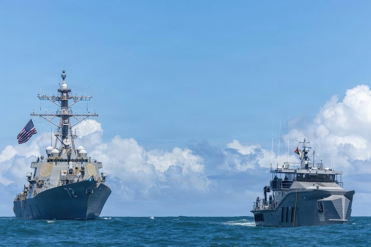 The U.S Navy Arleigh Burke-class guided-missile destroyer USS Winston S. Churchill, left, patrols with the Guyana Defence Force Defiant-class patrol vessel GDFS Shahous, right, during counter narcotics operations, November 22, 2025 in the Caribbean Sea - Zuma Press Wire
