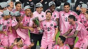 | Photo: AP/Rebecca Blackwell : Inter Miami forward Lionel Messi (10) holds the trophy as Inter Miami players celebrate winning an MLS Eastern Conference final soccer match against New York City FC, in Fort Lauderdale, Florida.